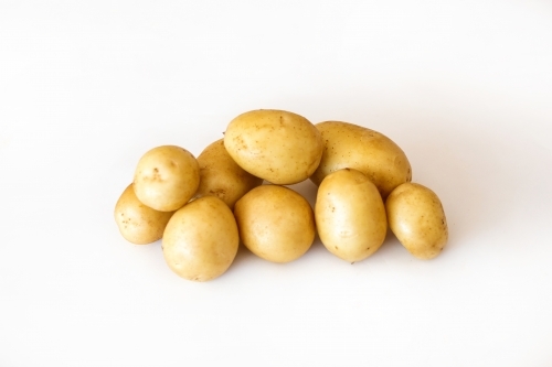 Potatoes on white backdrop - Australian Stock Image