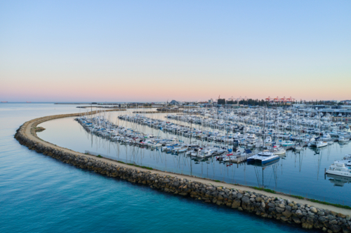 Pre-dawn view across yachts moored in a marina in Fremantle, Western Australia - Australian Stock Image