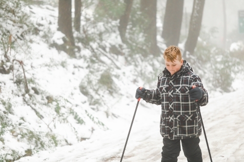 Pre-teen boy cross country skiing at Mount Stirling in the alpine region of Australia's high country - Australian Stock Image