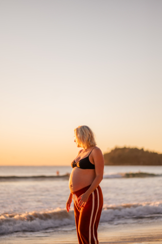 pregnant woman at Manly Beach during sunrise - Australian Stock Image