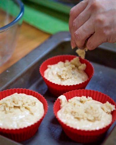 Preparing muffins in baking tray - Australian Stock Image