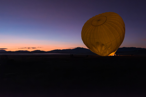 Prepping the hot air balloon at sunrise in Mareeba in the Atherton Tablelands - Australian Stock Image