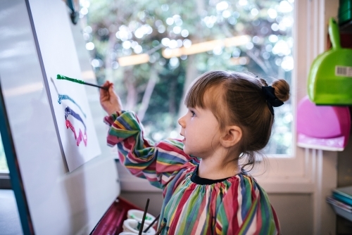 Preschool girl painting a picture - Australian Stock Image