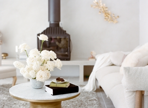 Pretty Bright Living Room with White Furnitures and Fire Place and White Roses