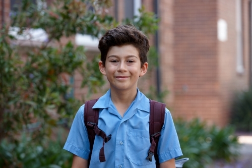 Primary school student at school with backpack - Australian Stock Image
