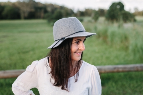 Profile of young woman outdoors smiling - Australian Stock Image