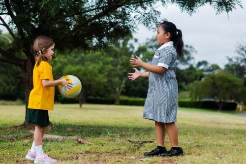 Public school girls playing a ball game outside - Australian Stock Image