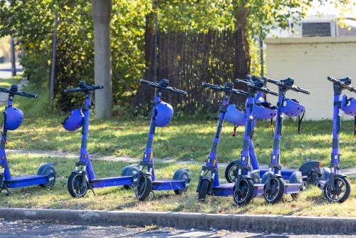 Purple e-scooters lined up in street for public use - Australian Stock Image