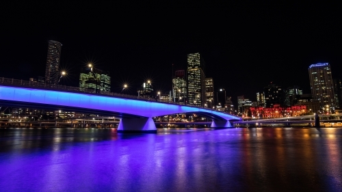 Purple lights over bridge and river