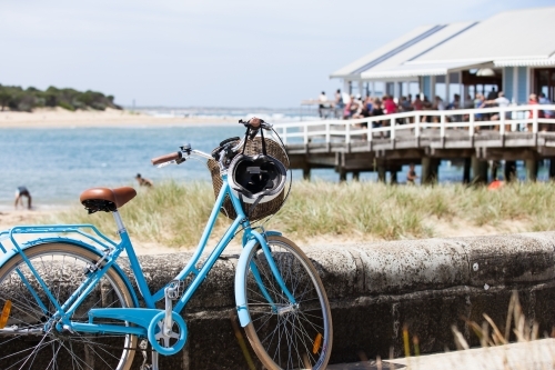 Push bike with restaurant and bay in background - Australian Stock Image