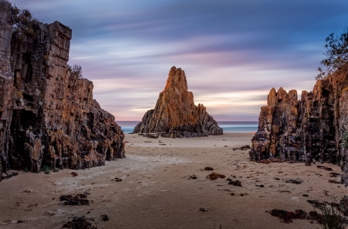 Pyramid rock sea stack long exposure movement of clouds across the sky during the dawn sunrise. - Australian Stock Image