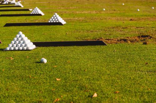 Pyramids of golf balls on a driving range - Australian Stock Image
