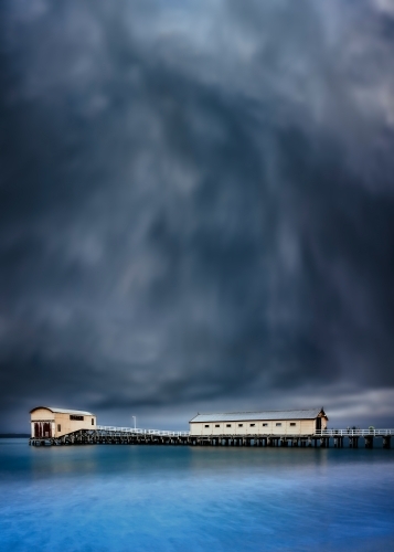 Queenscliff Pier with dramatic grey clouds overhead