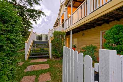 Queenslander home in Brisbane photographed at dusk - Australian Stock Image