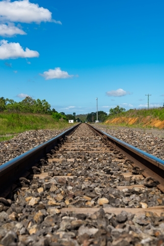 Rail tracks in Queensland countryside during summer - Australian Stock Image