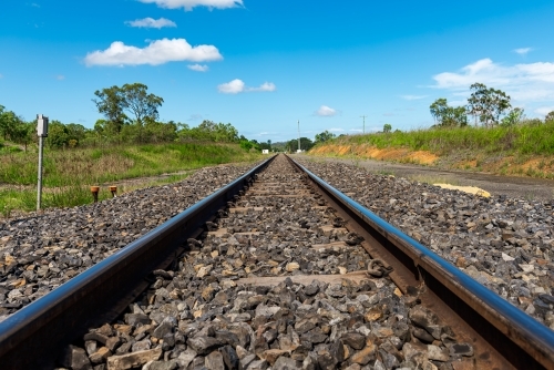 Rail tracks in Queensland countryside during summer - Australian Stock Image