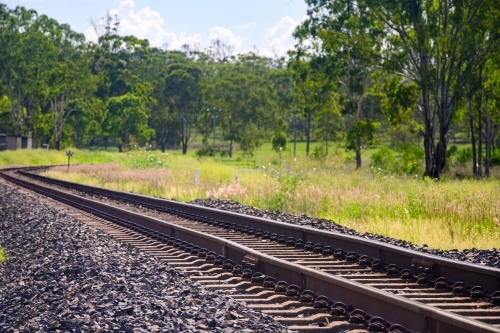 Rail tracks in Queensland countryside during summer - Australian Stock Image