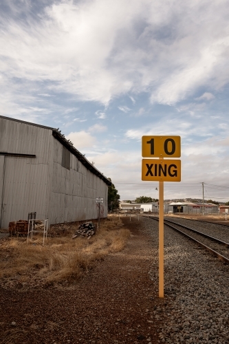 Railway sign next to railway shed and railway lines - Australian Stock Image