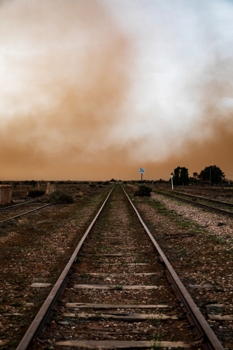 Railway tracks leading into dust storm - Australian Stock Image