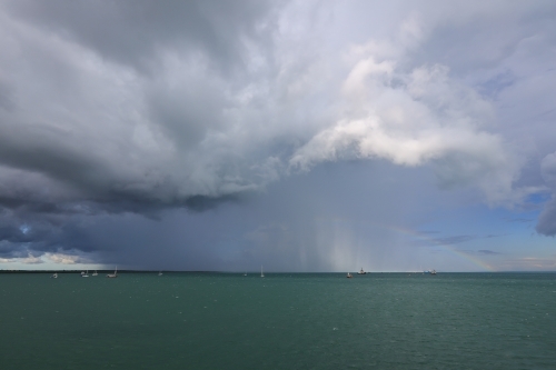 Rain over Darwin Harbour with rainbow - Australian Stock Image
