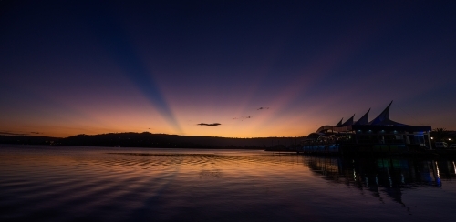 Rays of last light during a sunset at Gosford waterfront - Australian Stock Image