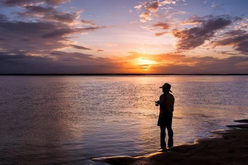 Recreational fisherman at sunset.