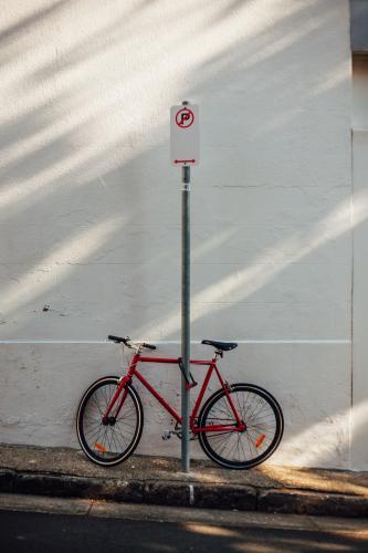 Red bike on urban street - Australian Stock Image