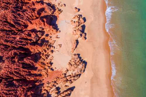 Red cliffs meet the ocean - Australian Stock Image
