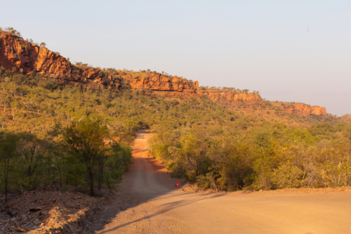 Red dirt outback gravel track in Northern Territory - Australian Stock Image