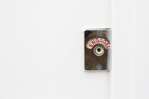Red engaged sign turned on in public toilet - Australian Stock Image