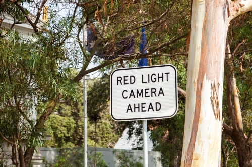 Red light camera ahead sign in city - Australian Stock Image