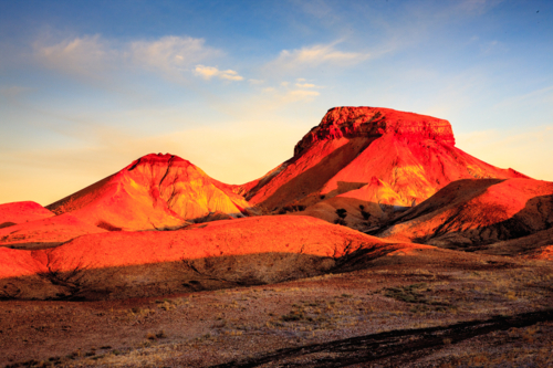 red sunset light on desert hills - Australian Stock Image