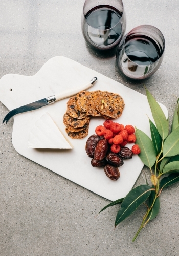 Red wine and a cheese plate. - Australian Stock Image