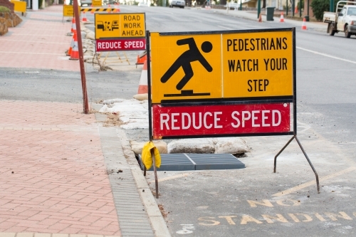 Reduce speed sign on street warning of road works - Australian Stock Image