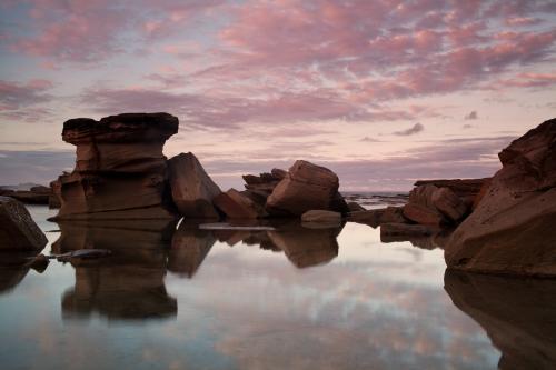 Reflection of rocks at the beach - Australian Stock Image
