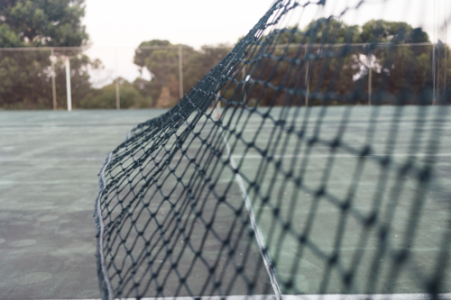 Regional Australia sport court containing netball and tennis facilities - Australian Stock Image