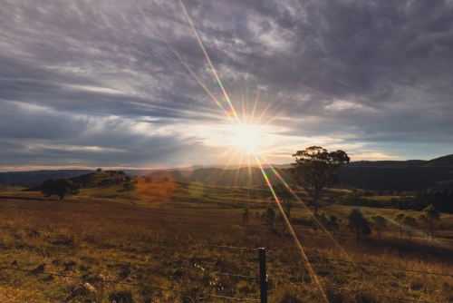 Regional NSW sunset landscape with vibrant sunburst - Australian Stock Image