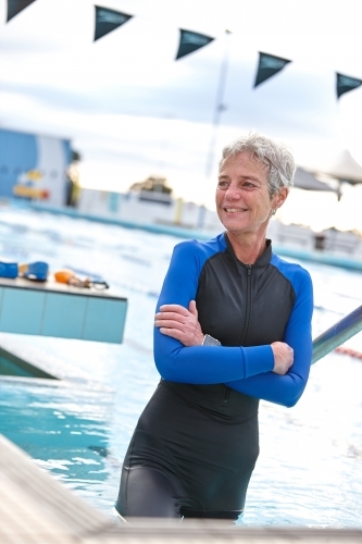 Relaxed active senior lady at swimming pool - Australian Stock Image