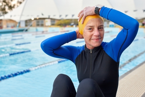 Relaxed active senior lady in swimming pool - Australian Stock Image