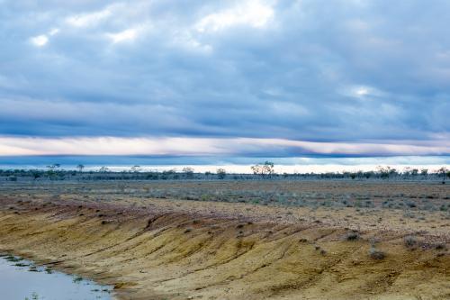 Remote barren landscape with empty dam - Australian Stock Image