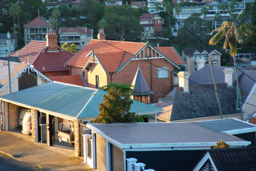 Residential area with multiple houses and buildings with various roof types. - Australian Stock Image
