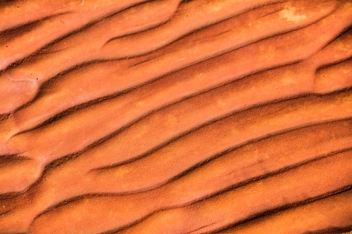 Rippled textured red rock that naturally occurs in Central Australia from when there was an inland s - Australian Stock Image