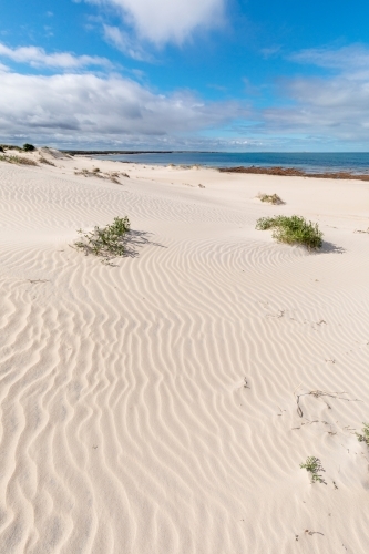 ripples on white sand dunes near beach - Australian Stock Image