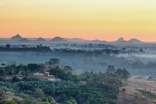 Rising mist over the Glasshouse Mountains - Australian Stock Image