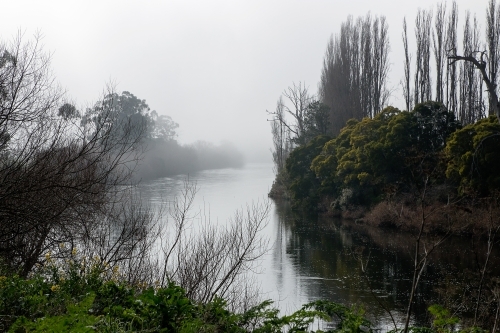 river bend on misty morning