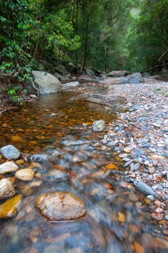 River flowing over a rocky boulder bottom - Australian Stock Image