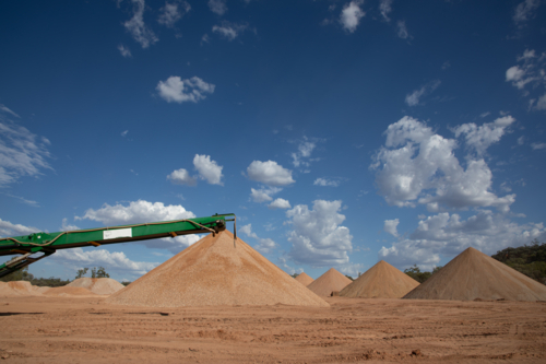 Road base gravel piles with machinery - Australian Stock Image