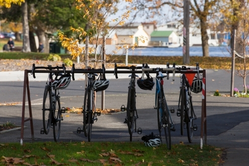 road bikes and helmets on a rack outside a cafe - Australian Stock Image