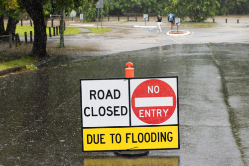 Road closed due to flooding sign on a suburban street in Brisbane - Australian Stock Image