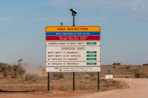 Road restrictions sign next to dirt road - Australian Stock Image